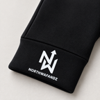 Close-up of the white NW arrow monogram and Northwafandz wordmark on the black glove cuff